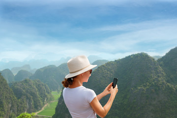 Modern technology and communication. Be online in travel. hiking and trekking concept. Young woman using smartphone