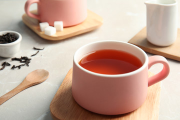 Obraz na płótnie Canvas Cup of black tea on table, closeup