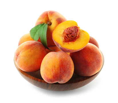 Bowl with fresh sweet peaches on white background
