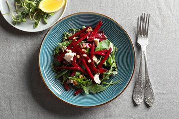 Plate with delicious beet salad on table, top view