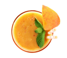 Tasty peach smoothie in glass on white background, top view