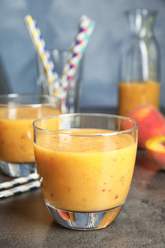 Tasty peach smoothie on table. Healthy drink