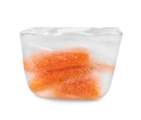 Fresh carrot in ice cube on white background. Frozen vegetables