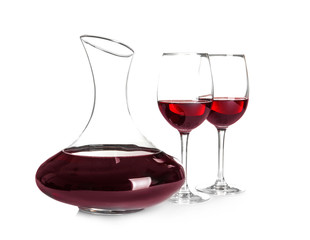 Elegant decanter and glasses with red wine on white background