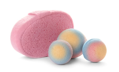 Pink sponge and bath bombs on white background