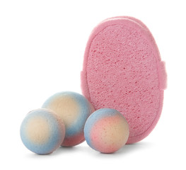 Pink sponge and bath bombs on white background