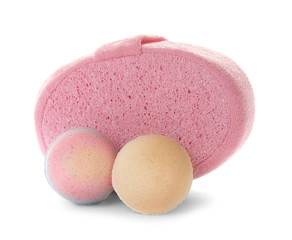 Pink sponge and bath bombs on white background
