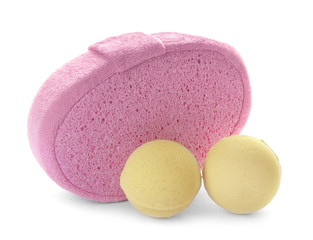 Pink sponge and bath bombs on white background