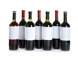 Bottles with red wine on white background
