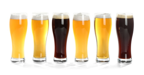 Glasses with different beer on white background