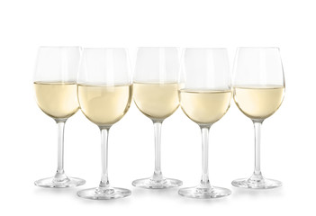 Glasses with white wine on light background