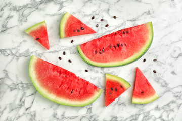 Flat lay composition with slices and seeds of watermelon on marble background