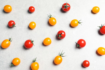 Flat lay composition with juicy tomatoes on grey background