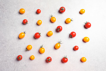Flat lay composition with juicy tomatoes on grey background