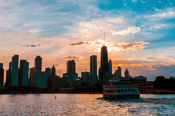Chicago skyline viewed from the pier on Lake Michigan with sunset sky in the background