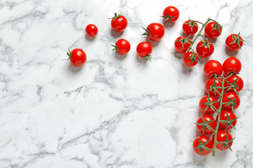 Flat lay composition with juicy tomatoes and space for text on marble background