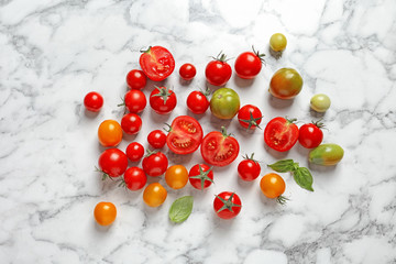 Flat lay composition with juicy tomatoes on marble background