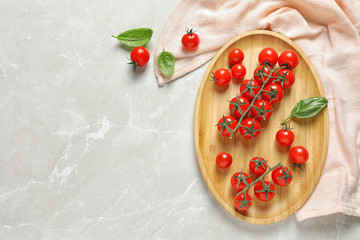 Flat lay composition with juicy tomatoes and space for text on grey background