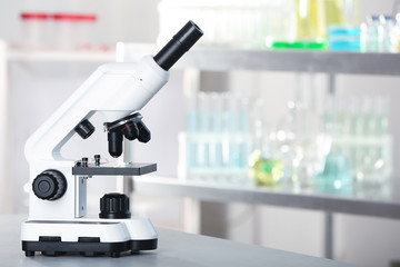 Modern microscope on table in laboratory. Chemical analysis