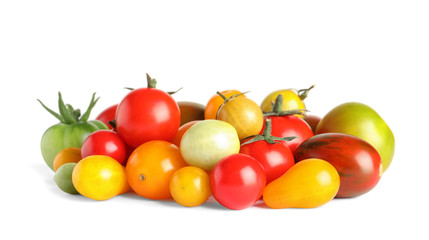 Different colorful tomatoes on white background
