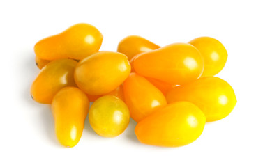 Tasty yellow tomatoes on white background