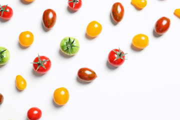 Flat lay composition with different tasty tomatoes on white background