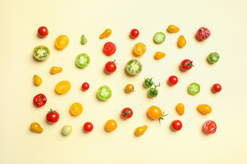 Flat lay composition with different tasty tomatoes on color background