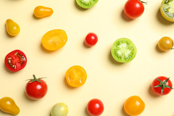 Flat lay composition with different tasty tomatoes on color background