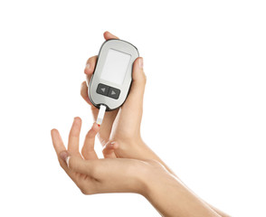 Woman checking blood sugar level with glucometer on white background. Diabetes test