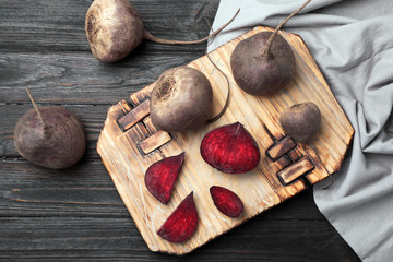 Flat lay composition with ripe beets on wooden background
