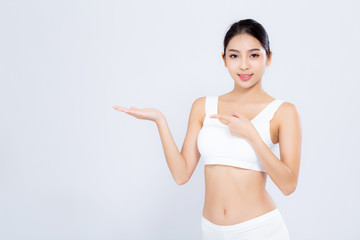 Fototapeta premium Beautiful portrait young asian woman fit smiling gesture showing presenting something empty on hand isolated on white background, healthy and diet concept.