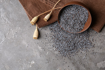 Flat lay composition with poppy seeds on grey background