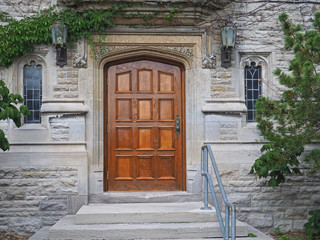wooden door of gothic style college building