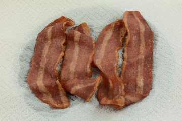 Close up of microwaved turkey bacon cooked on paper towel to reduce and absorb excess grease