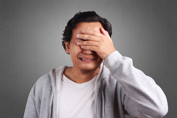 Young Man Cried, Covering Eyes with Hand