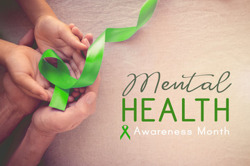 Adult and child hands holding Lime GreenRibbon, Mental health awareness month