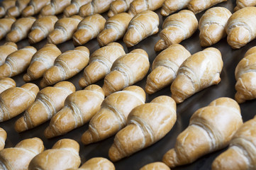 Baked croissants group on the production line