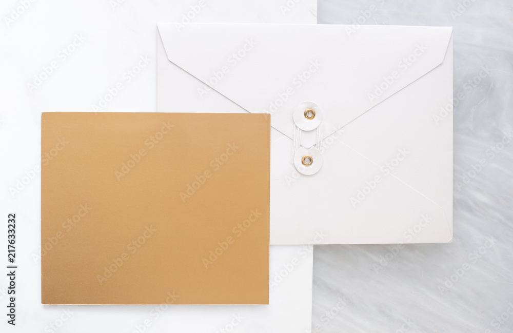 Poster Top view of blank gold card overlap on white envelop on two layer step of marble table top.Mock up template for display of design .luxury business items.