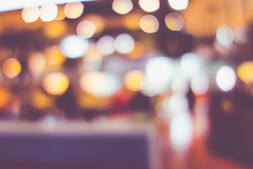 Blurred background of customer sitting in coffee shop or cafe restaurant with bokeh light.