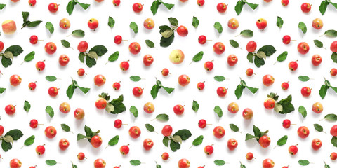 Seamless pattern of fresh red  apples with green leaves isolated on a white background, top view, flat lay. Food texture.