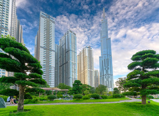 Obraz premium Ho Chi Minh City, Vietnam - August 1st, 2018: Skyscrapers viewed from below towards sky represents urban development with modern architecture to bring international in Ho Chi Minh City, Vietnam