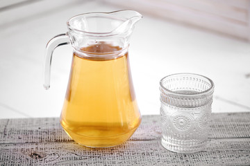 The carafe of juice on a white background