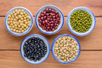 Various kinds of beans,different kinds of beans in bowl on wooden table.