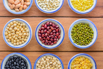Various kinds of beans,different kinds of beans in bowl on wooden table.