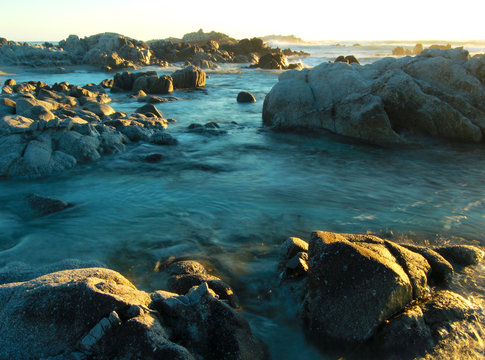Romantic sunset at rocky coastline of Asilomar State Reserve, Pacific Grove near Monterey and Carmel, California, USA