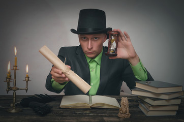 Man in bowler with top secret documents in hands is sitting by table. Detective or spy agent or...