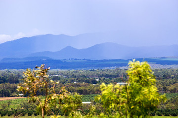 Fototapeta premium Misty hills and agricultural fields on the Atherton Tableland in Tropical North Queensland, Australia
