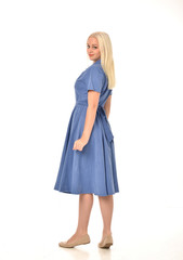 full length portrait of blonde girl wearing blue dress, standing pose. isolated on white  studio background.