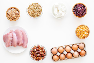 Healthy food. Products rich protein and fiber. Legumes, nuts, low-fat cheese, meet, eggs. Raw beans, chickpeas, lentil, almond, hazelnut on white background top view copy space