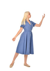 full length portrait of blonde girl wearing blue dress, standing pose. isolated on white  studio background.